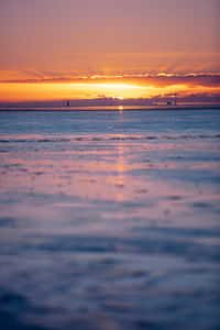 Scenic view of sea against romantic sky at sunset