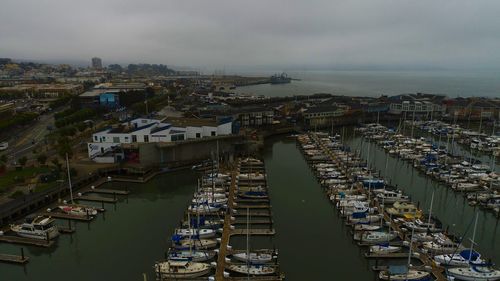 High angle view of city by sea against sky