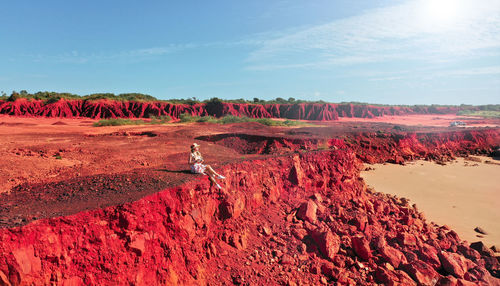 Red rock formations on landscape against sky