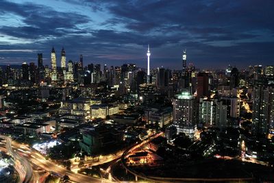 Illuminated cityscape against sky at night