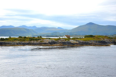 Scenic view of land and mountains against sky