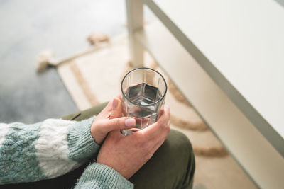 Cropped hand of woman using mobile phone