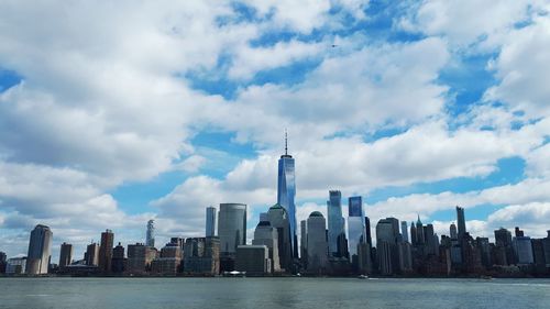 View of skyscrapers against cloudy sky