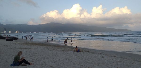 People on beach against sky