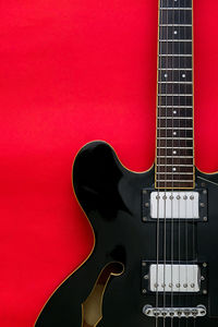 Close-up of guitar against black background