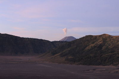 Scenic view of arid landscape against sky