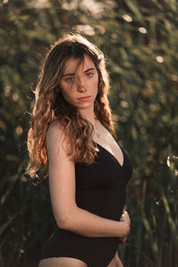Portrait of a beautiful young woman standing outdoors