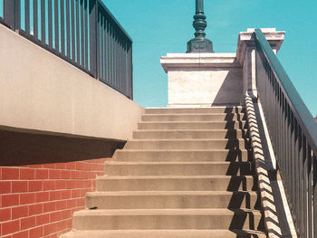 Low angle view of staircase amidst buildings in city