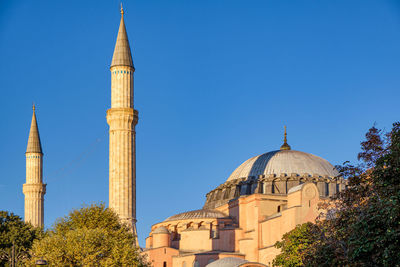 Low angle view of mosque against clear sky