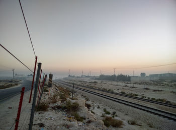 Railroad tracks against clear sky during winter