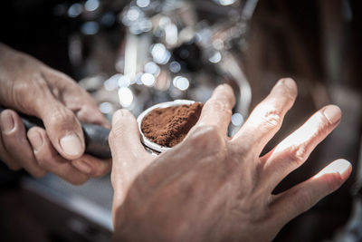 Cropped image of barista making coffee at cafe