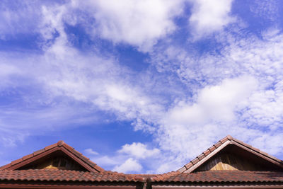 Low angle view of building against cloudy sky