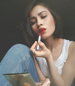 Woman applying lipstick