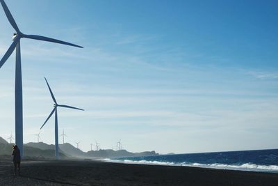 Scenic view of wind turbines on beach
