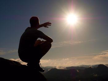 Freedom hiker sit upper the misty valley and enjoy morning in beautiful nature