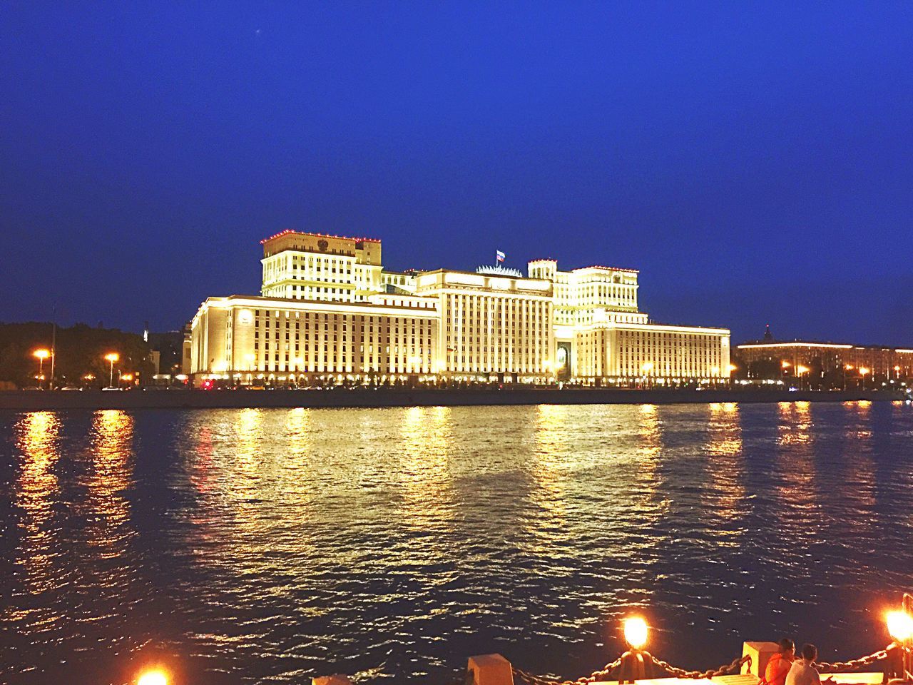 water, architecture, illuminated, built structure, blue, building exterior, reflection, river, clear sky, city, waterfront, sea, outdoors, tranquility, scenics, tranquil scene, city life, riverbank, no people, skyline, water surface, urban skyline, tall, residential district, ocean