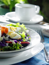 Close-up of salad with boiled eggs in plate on table