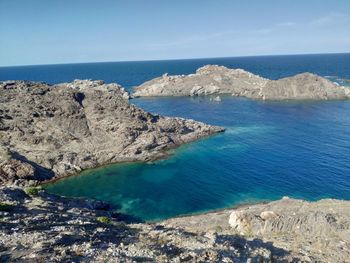 Scenic view of sea and rocks against sky