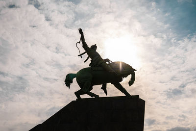 Low angle view of statue against sky