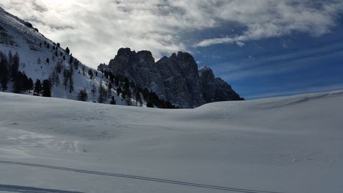 Scenic view of snow covered mountains against sky