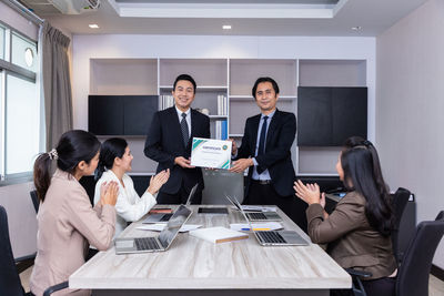 Business colleague showing certificate