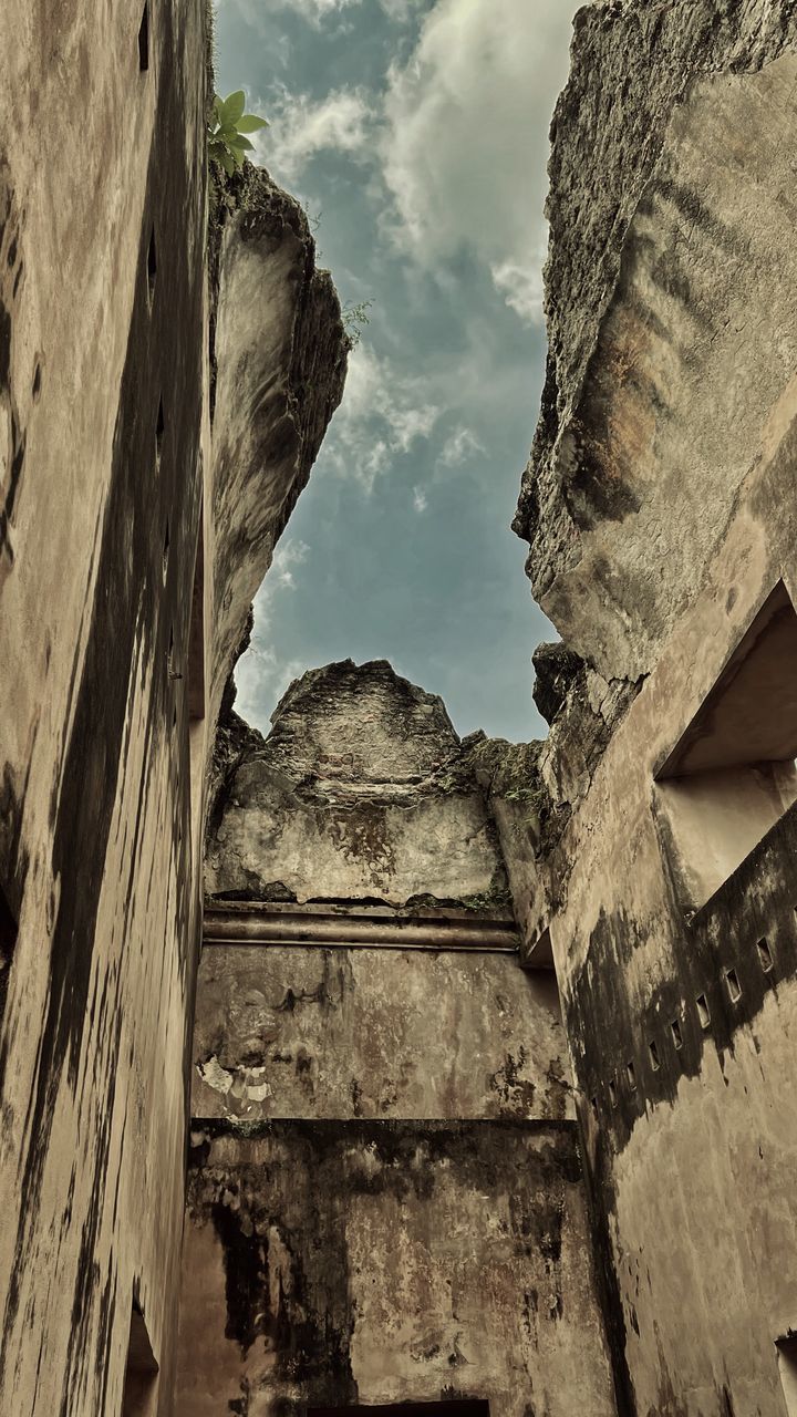 rock, architecture, built structure, history, sky, the past, ancient history, no people, low angle view, nature, temple, ruins, cloud, building exterior, wall, ancient, travel destinations, building, day, outdoors, old, old ruin, white, travel, ancient civilization, wall - building feature, tourism, stone material