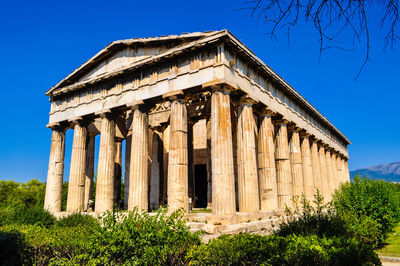 Low angle view of historical building against clear blue sky