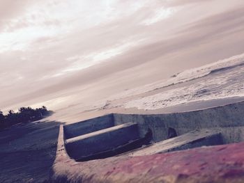 Scenic view of beach against sky during winter