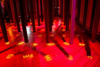 High angle view of illuminated text on floor in building