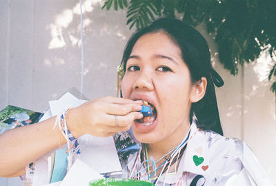 Portrait of young woman eating food