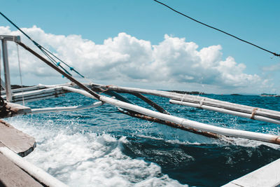 Boat sailing in swimming pool by sea against sky