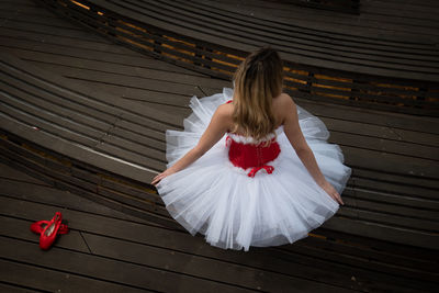 Portrait of young woman standing on boardwalk