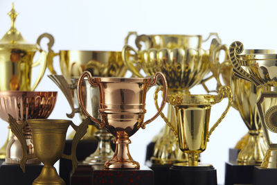 Close-up of trophies against white background
