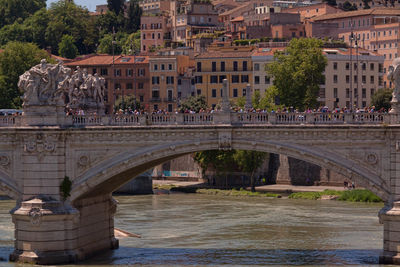 Ponte sant angelo over river against buildings