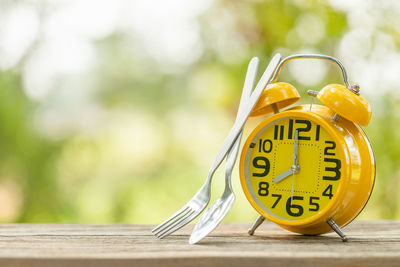 Close-up of clock on table