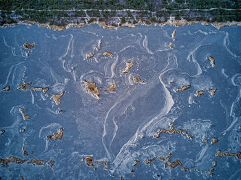 High angle view of footprints on wet sand