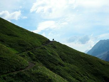 Scenic view of mountains against cloudy sky