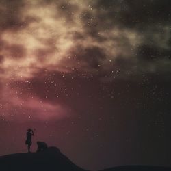 Low angle view of silhouette people against star field at night