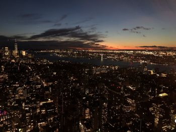 High angle view of illuminated city against sky at night