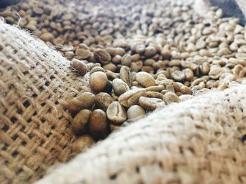 Close-up of roasted coffee beans in sack