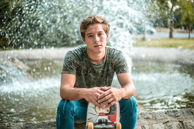 Portrait of young man standing in water