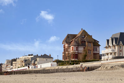 Houses on beach against sky