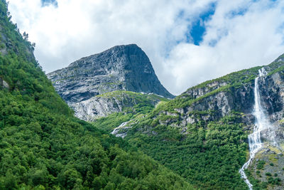 Scenic view of waterfall against sky