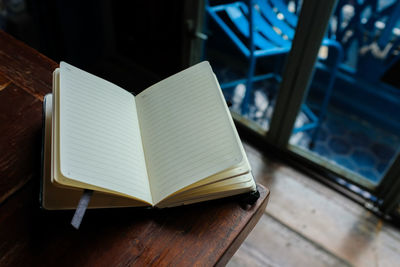 High angle view of open book on table at home