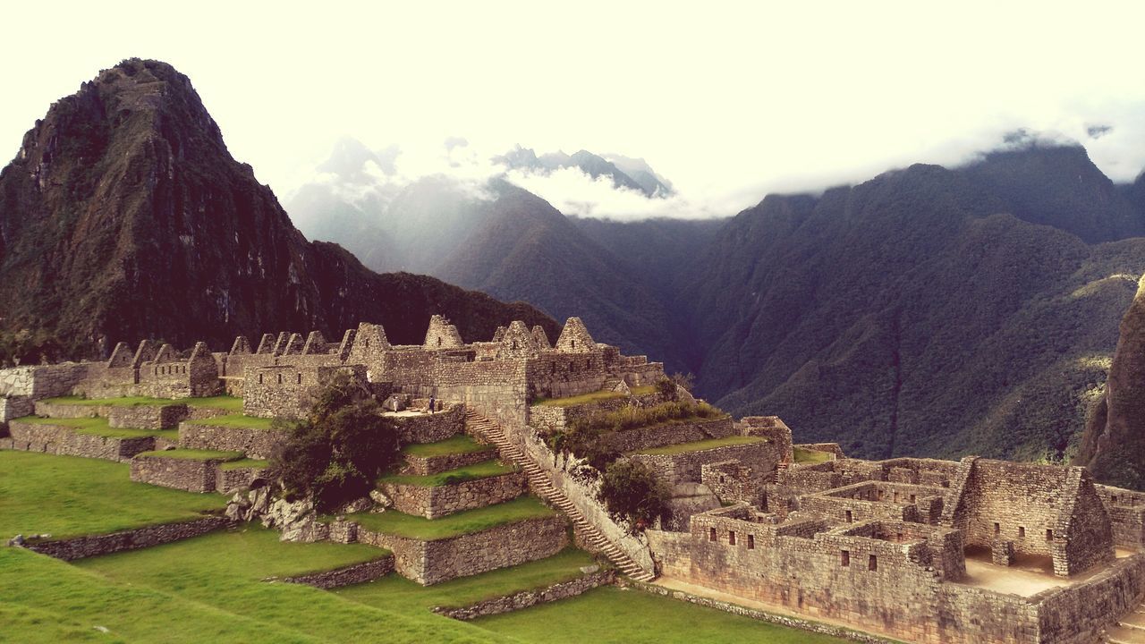 architecture, built structure, building exterior, mountain, history, landscape, ancient, sky, travel destinations, famous place, old ruin, the past, ancient civilization, tourism, travel, tranquility, scenics, international landmark, tree, grass