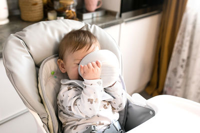 Cute baby sleeping on sofa at home