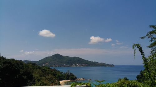 Scenic view of sea and mountains against sky