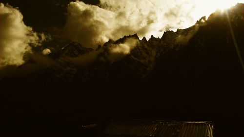 Scenic view of mountains against cloudy sky