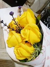 High angle view of yellow roses on table