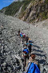 High angle view of people hiking on mountain